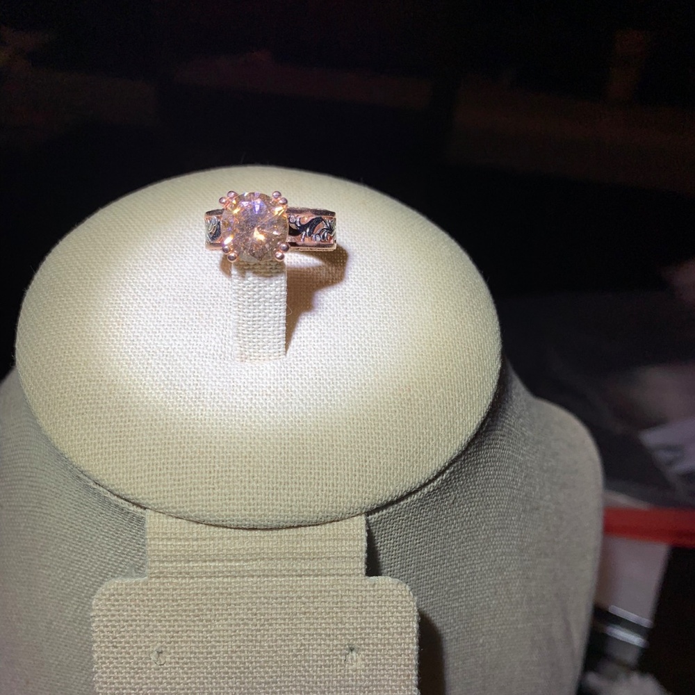 Gold tone filigree ring with peachy CZ